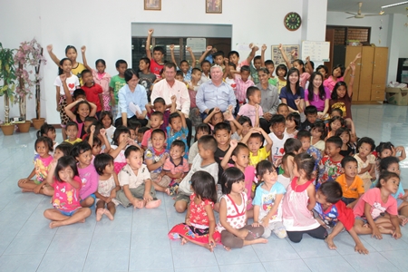 Having raised a considerable sum of money from a charity golf tournament organized by the Cuel Co. Ltd. and its affiliates recently, Steve Hovi (seated 2nd left), the pre-commissioning manager donated 1,573,000 baht to the Fountain of Life Center for use in caring for the children at the centre.